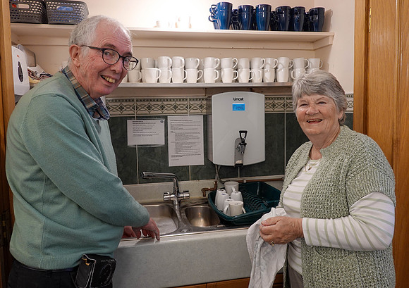 Derek and Liz washing up in church kitchen